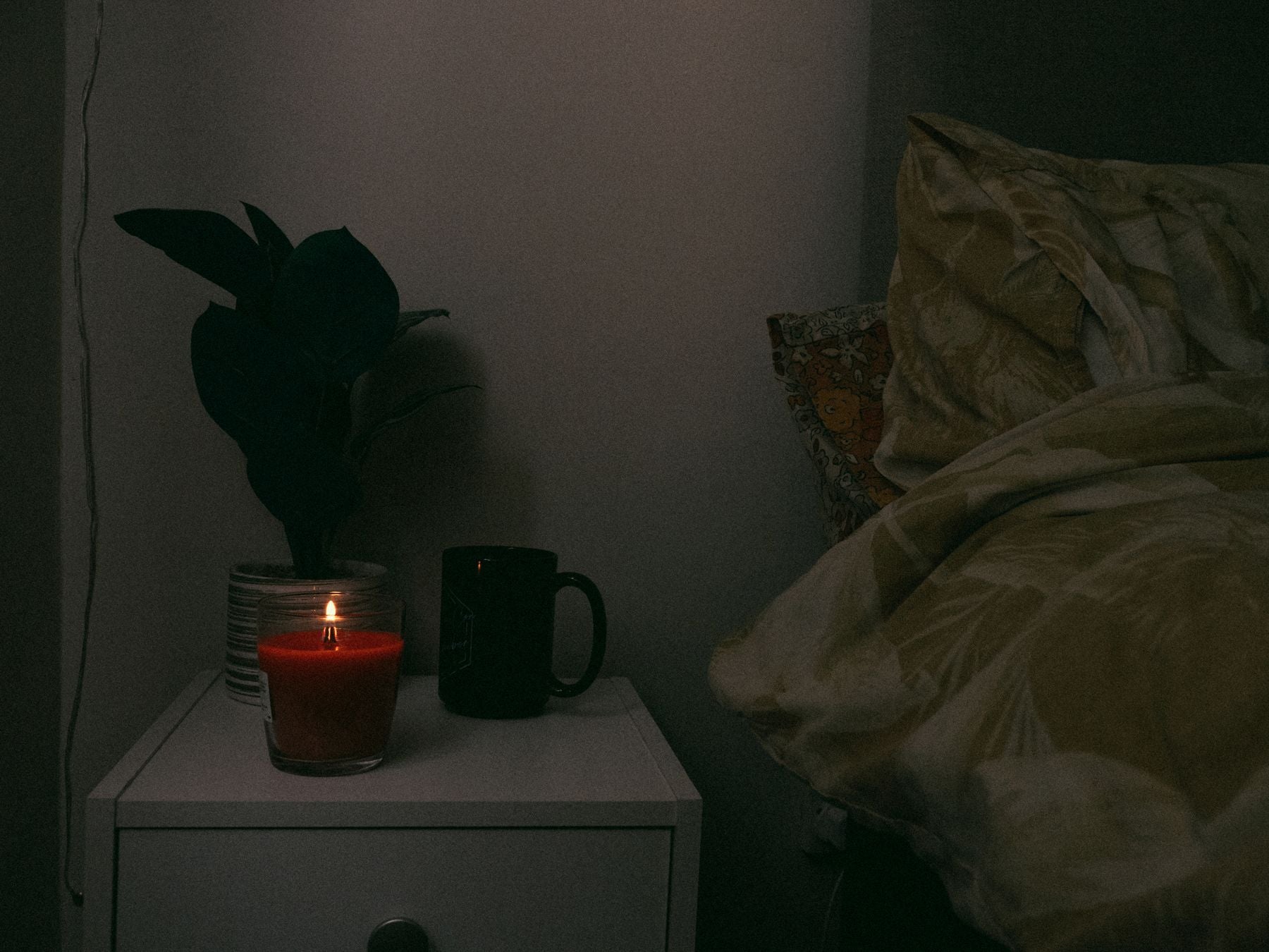 A calming evening ritual with journal, tea, herbs, and candle