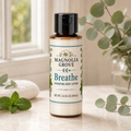 Breathe Hydrating Body Lotion bottle, 3.4 fl oz, styled with eucalyptus and mint greenery