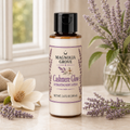 Cashmere Glow Hydrating Body Lotion bottle, 3.4 fl oz, in a soft floral setting