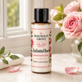 Enchanted Rose Hydrating Body Lotion bottle, 3.4 fl oz, styled with pink roses