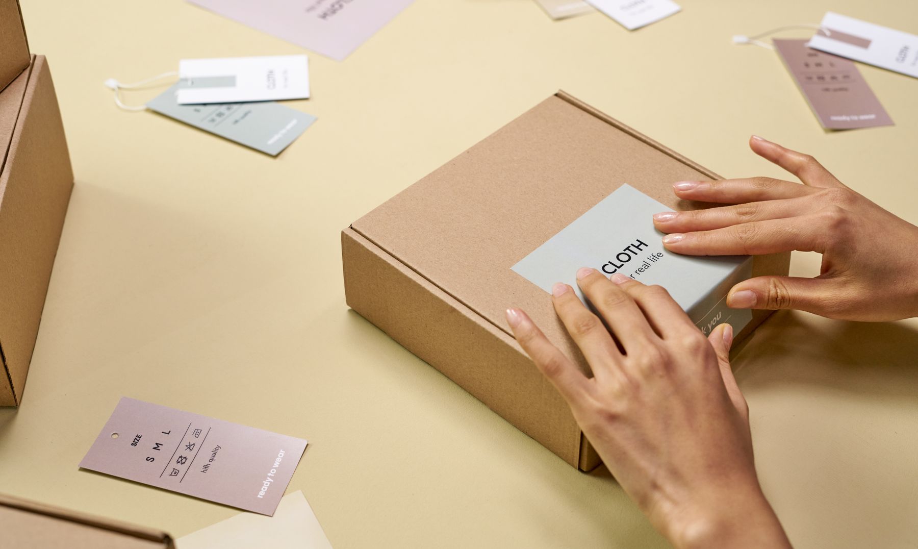 Hands labeling a handmade candle