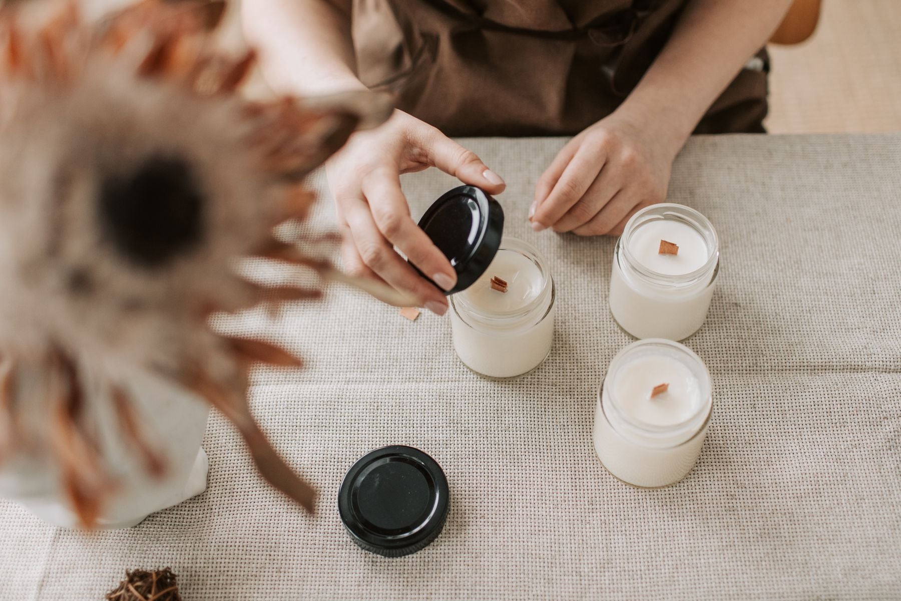 Magnolia Grove candles being finished by hand